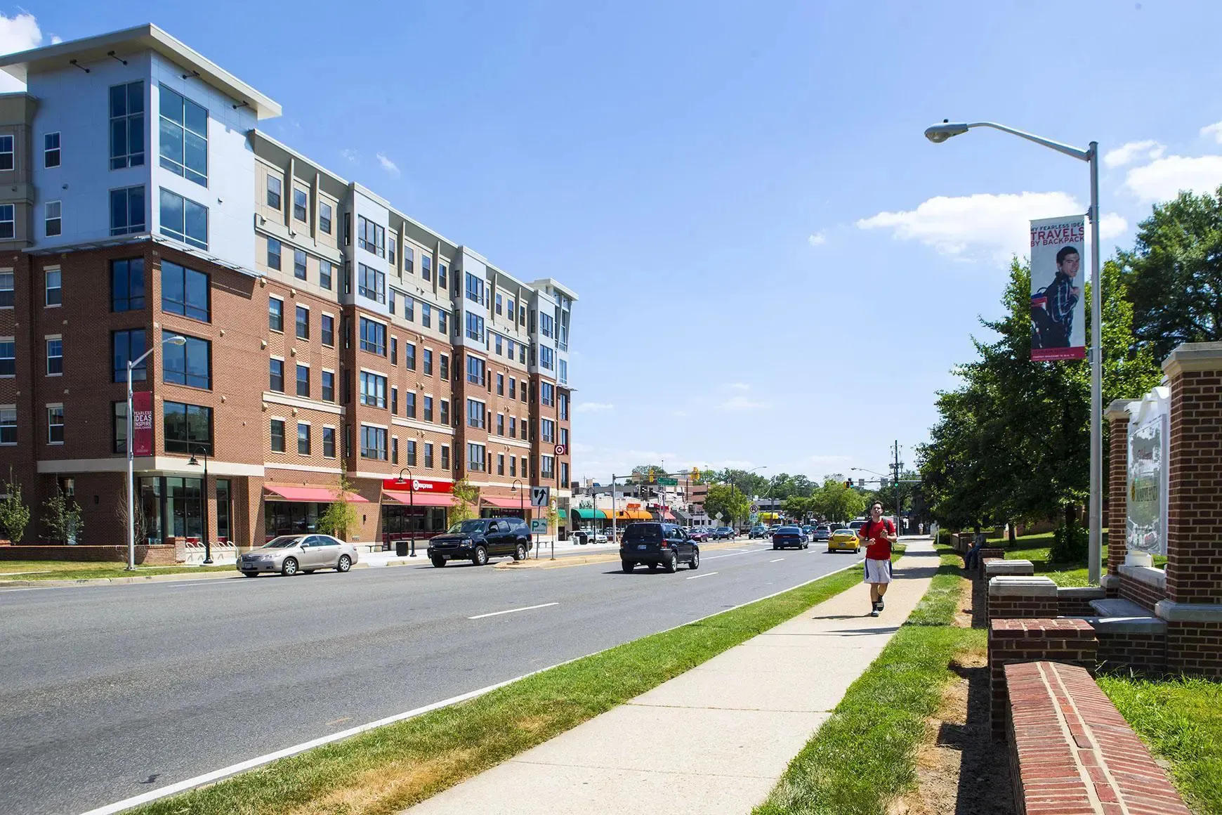 Student walking along Baltimore Avenue outside of the University of Maryland campus in College Park, MD