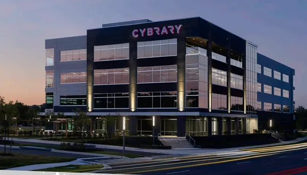 A sunset sky reflects off of the Cybrary building on 4600 River Road