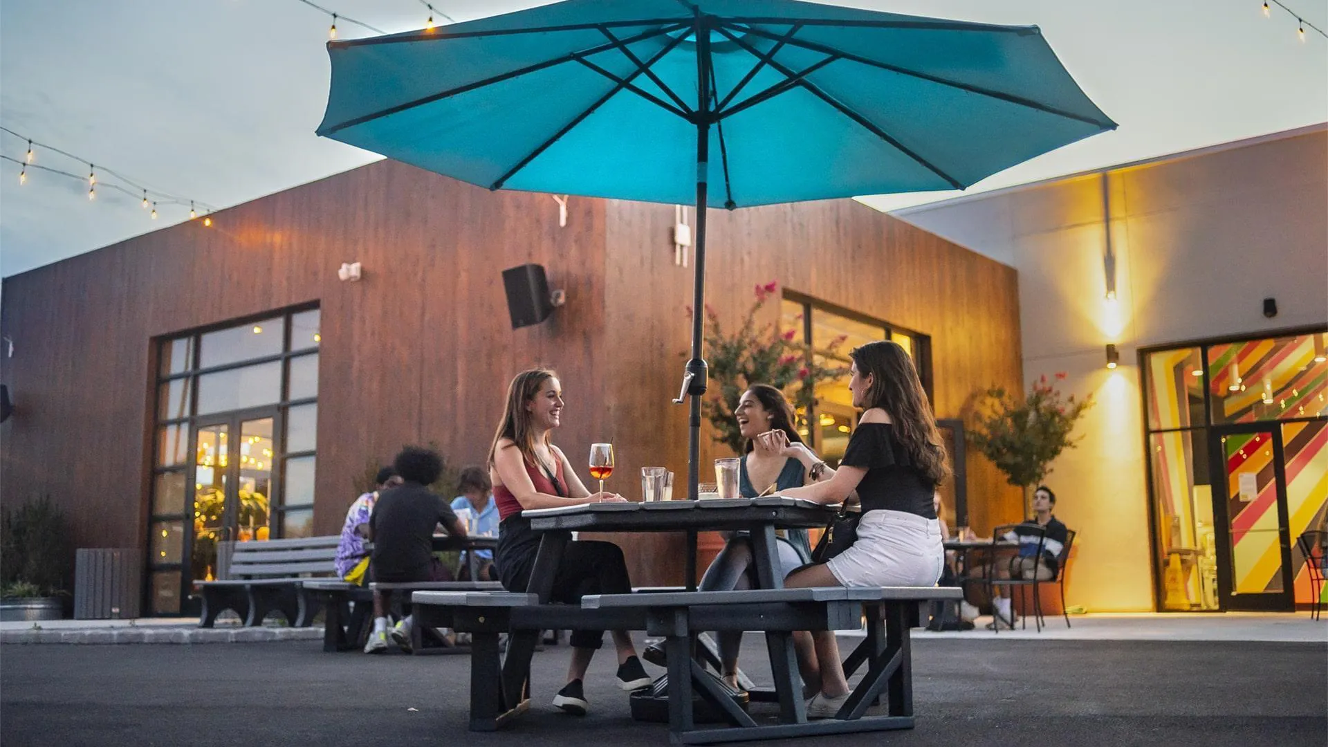 Women enjoy outdoor drinks and dining at the Hall CP in College Park, MD