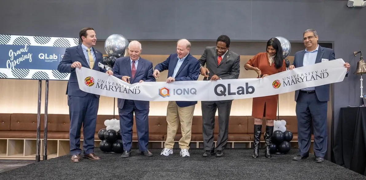 Individuals cutting the ribbon for the QLab ceremony