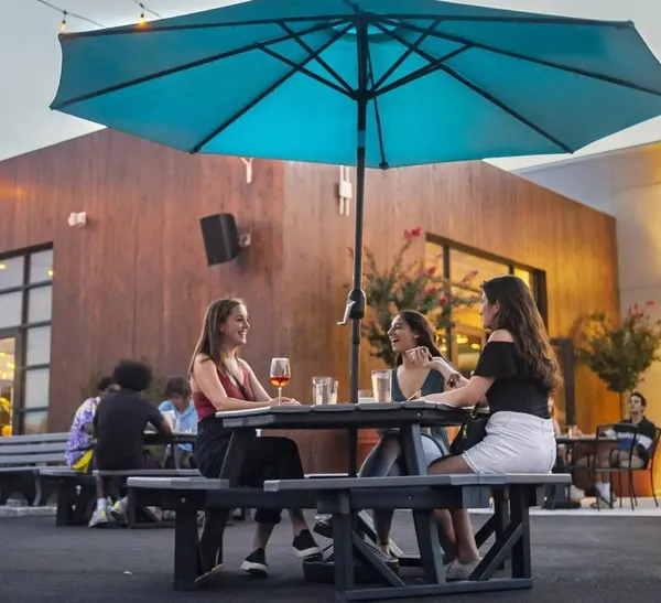 Women enjoy outdoor drinks and dining at the Hall CP in College Park, MD
