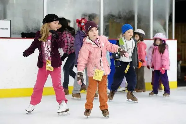 A group of kids skating at Herbert Wells Ice Rink