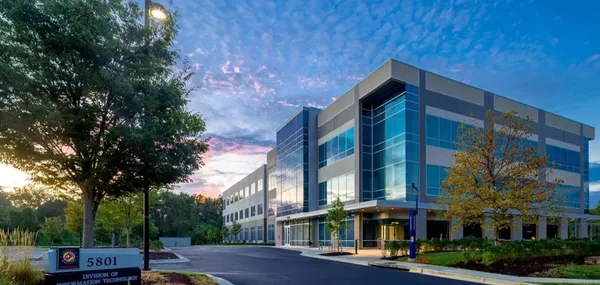 Digital rendering of 5801 University Research Court with sunset glowing in the clouds above