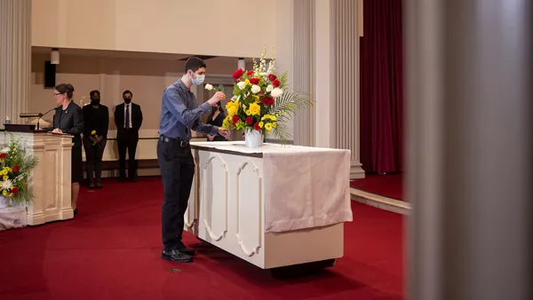 person arranging flowers