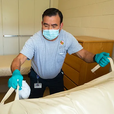 a Residential Facilities staff person cleaning