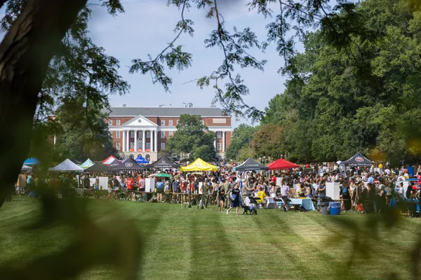 A crowd of students visit tents from various student groups at the First Look Fair