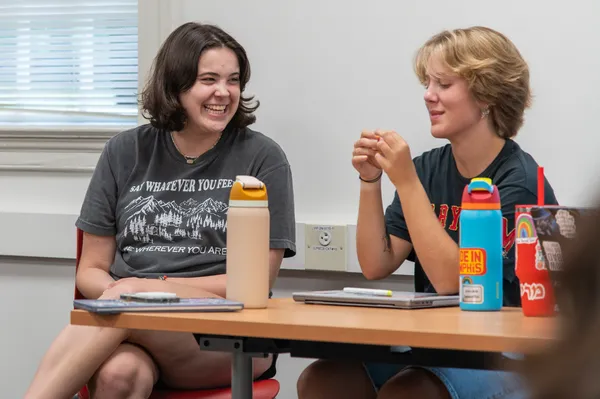 Two students in the RADical Health program laugh together