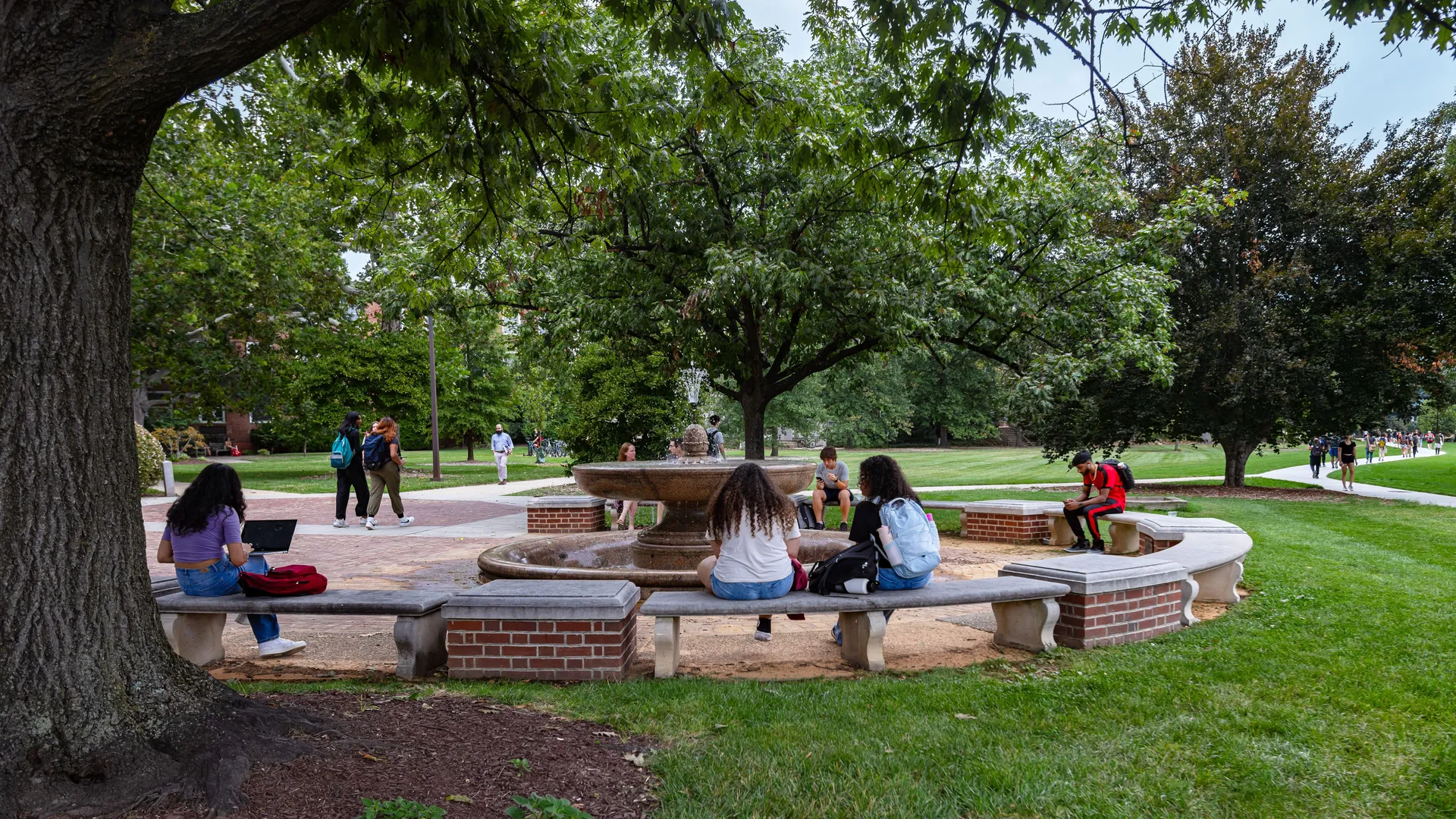 Students Outdoors Sitting at Fountain