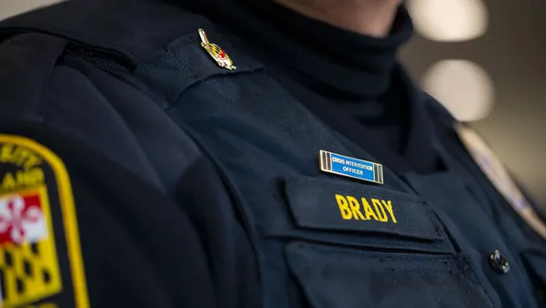 Close-up of the crisis intervention officer pin on the uniform of a University of Maryland police officer