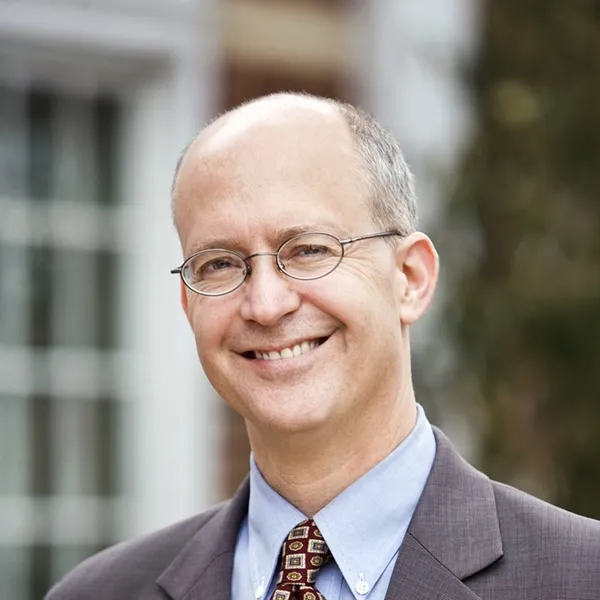 Full color headshot of Ross Stern smiling and wearing a suit